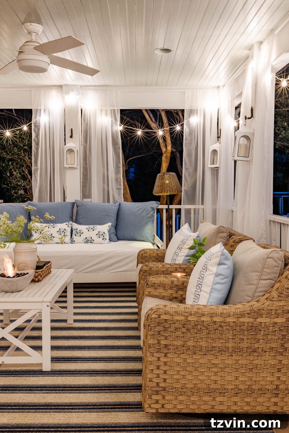 Our DIY Outdoor Living Room: Seamlessly Extending Our Home 17 Beautiful outdoor living room with a fireplace, comfortable seating, and soft lighting on a back porch.