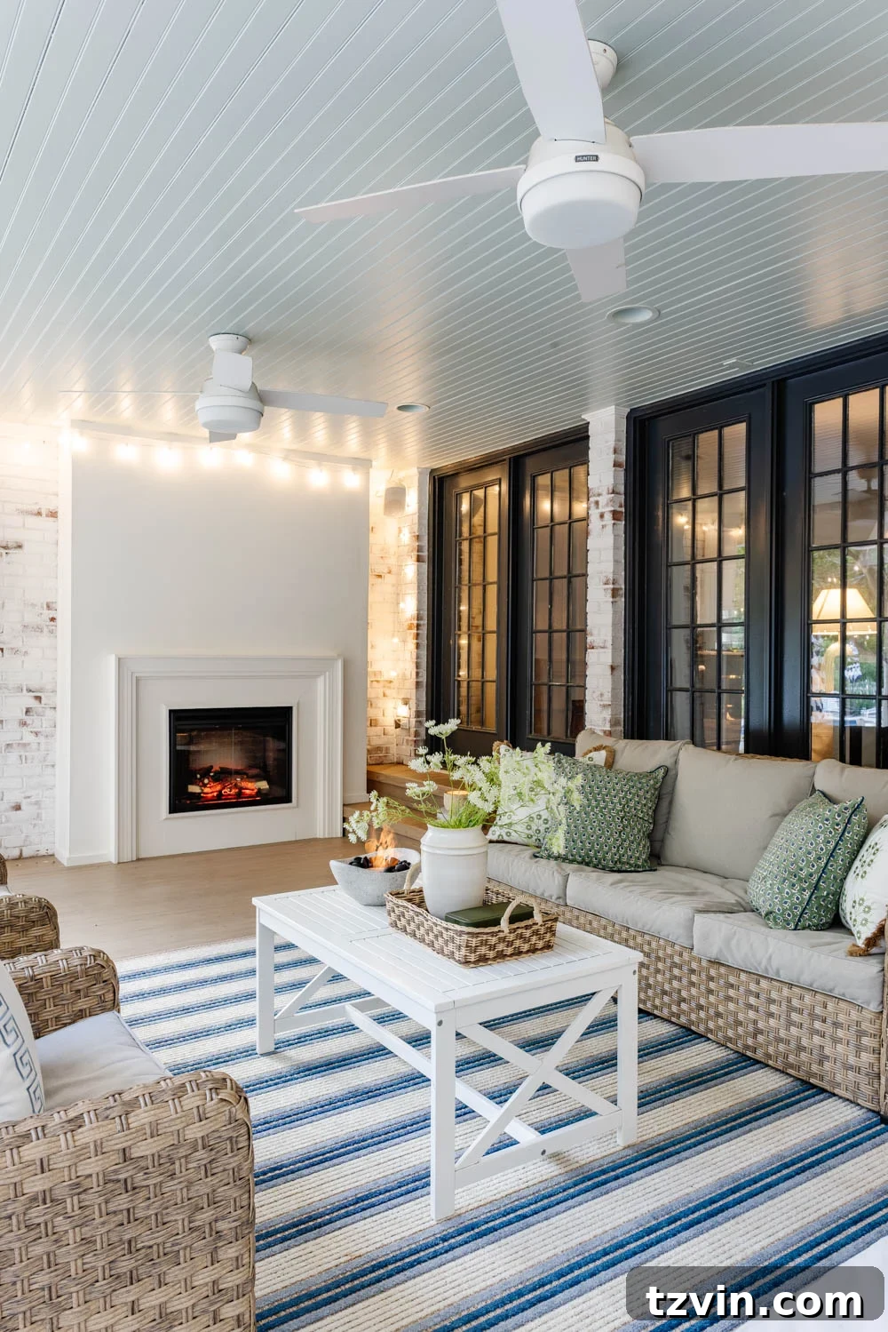 Our DIY Outdoor Living Room: Seamlessly Extending Our Home 4 Finished outdoor living room with a stylish fireplace, comfortable seating, and elegant decor on a back porch.