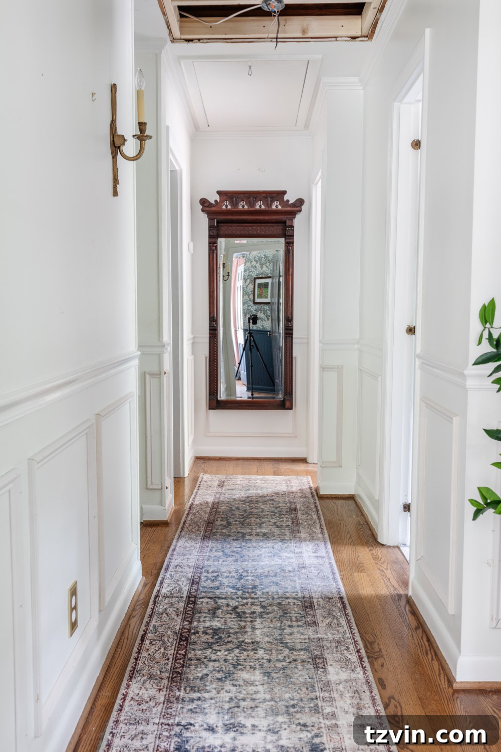 Our Hallway Vision: Mood Board and Renovation Blueprint 2 Beautifully updated hallway with a new ceiling and lighting, showcasing a seamless blend of modern and vintage design elements after attic door removal