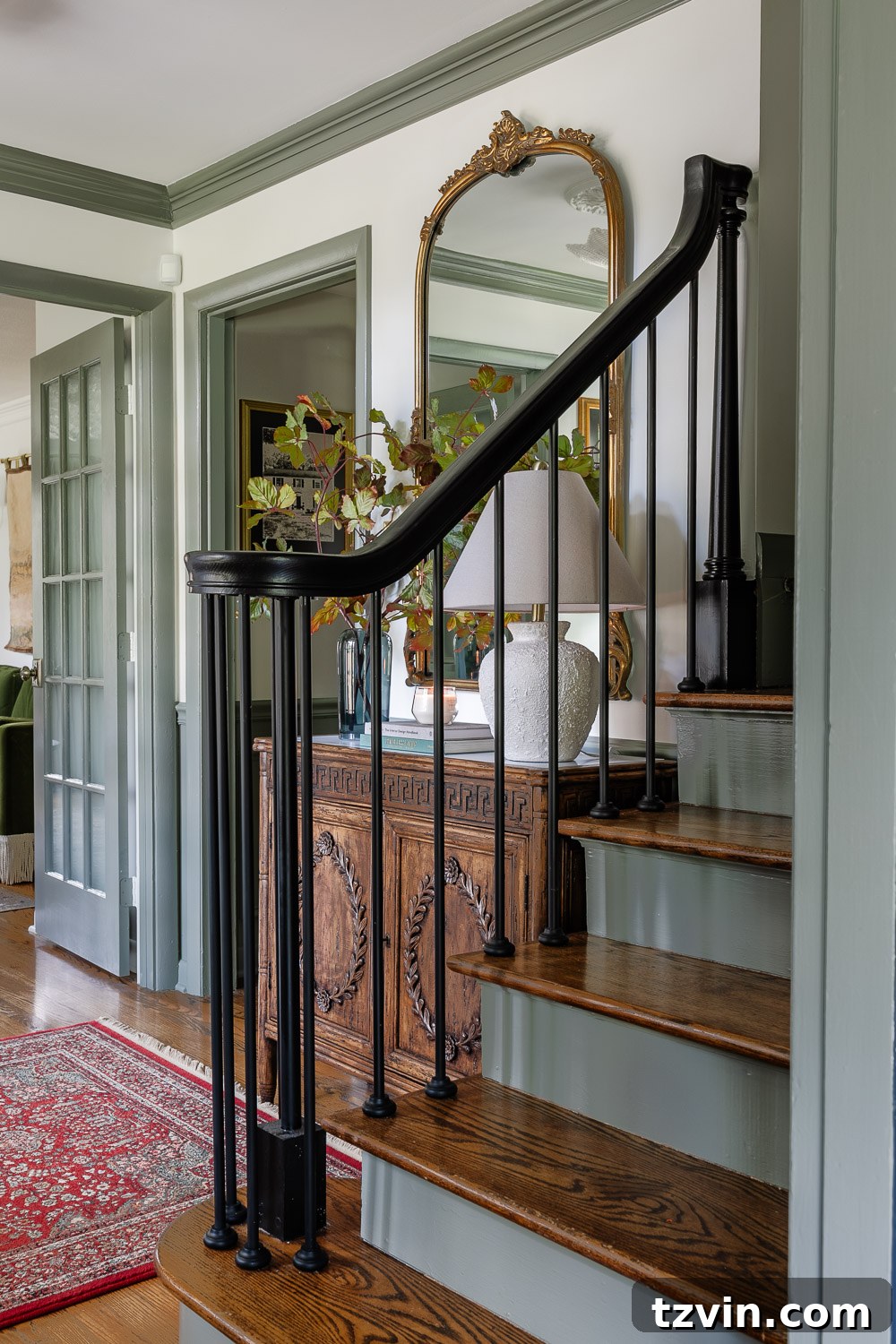 Transform Your Home This Long Weekend: 100+ Quick Ideas 7 Modern traditional foyer with painted stair risers and a large mirror.