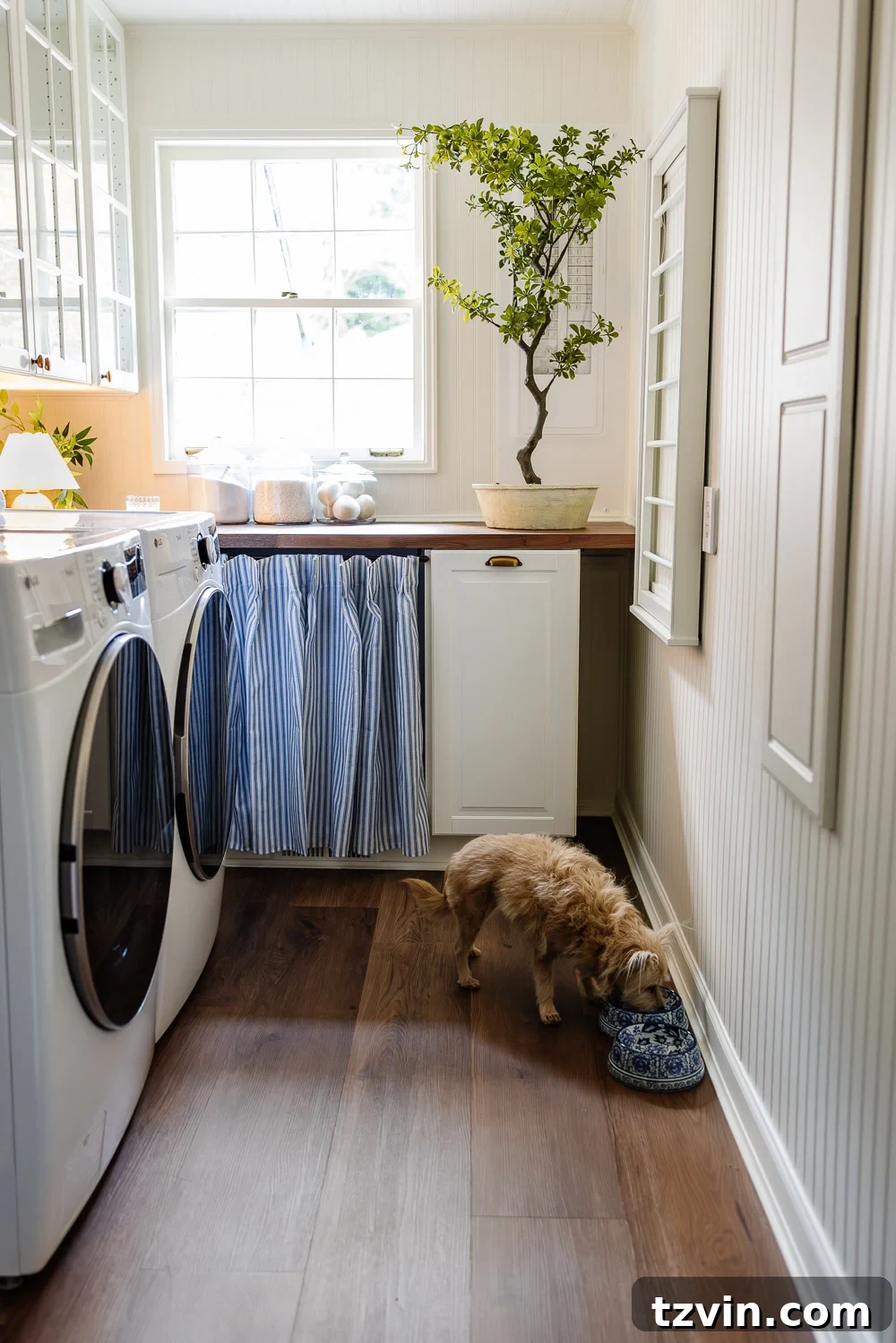 Beautiful narrow laundry room with IKEA cabinets and vintage Nancy Meyers style beadboard walls