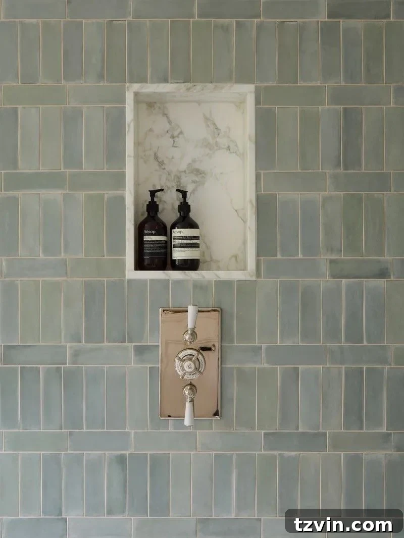 Stylish recessed shower niche tiled to match the shower, holding bottles.