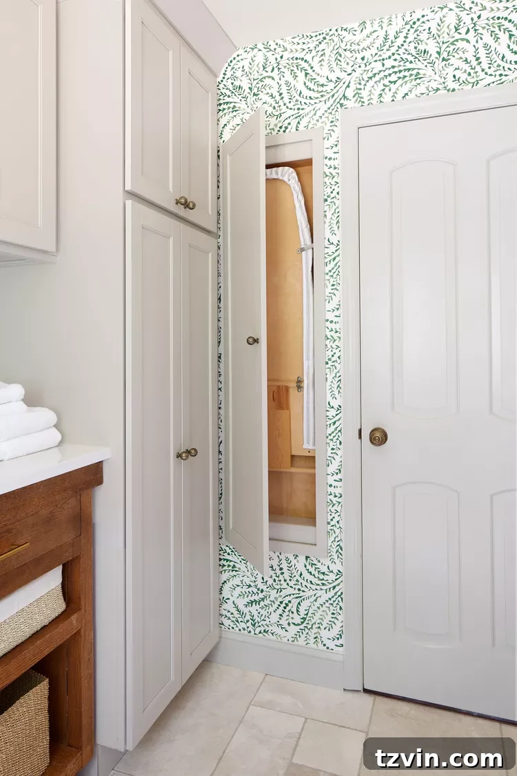 Hidden ironing board cupboard neatly folded and stored within a wall cavity.