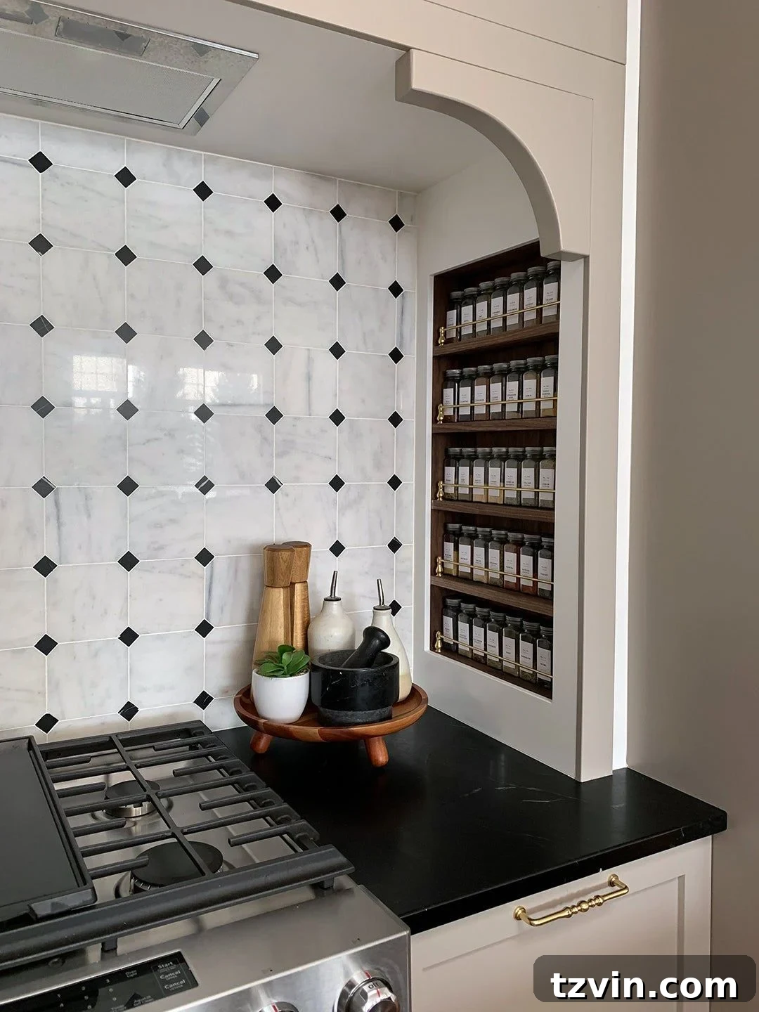 Recessed spice rack built into a kitchen wall between studs, providing accessible storage.
