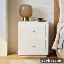 Tiny Bedroom Solutions: 20+ Space-Saving Nightstands 16 Elegant cream-colored slim bedside table with reeded details and brass legs, adding texture to the bedroom.