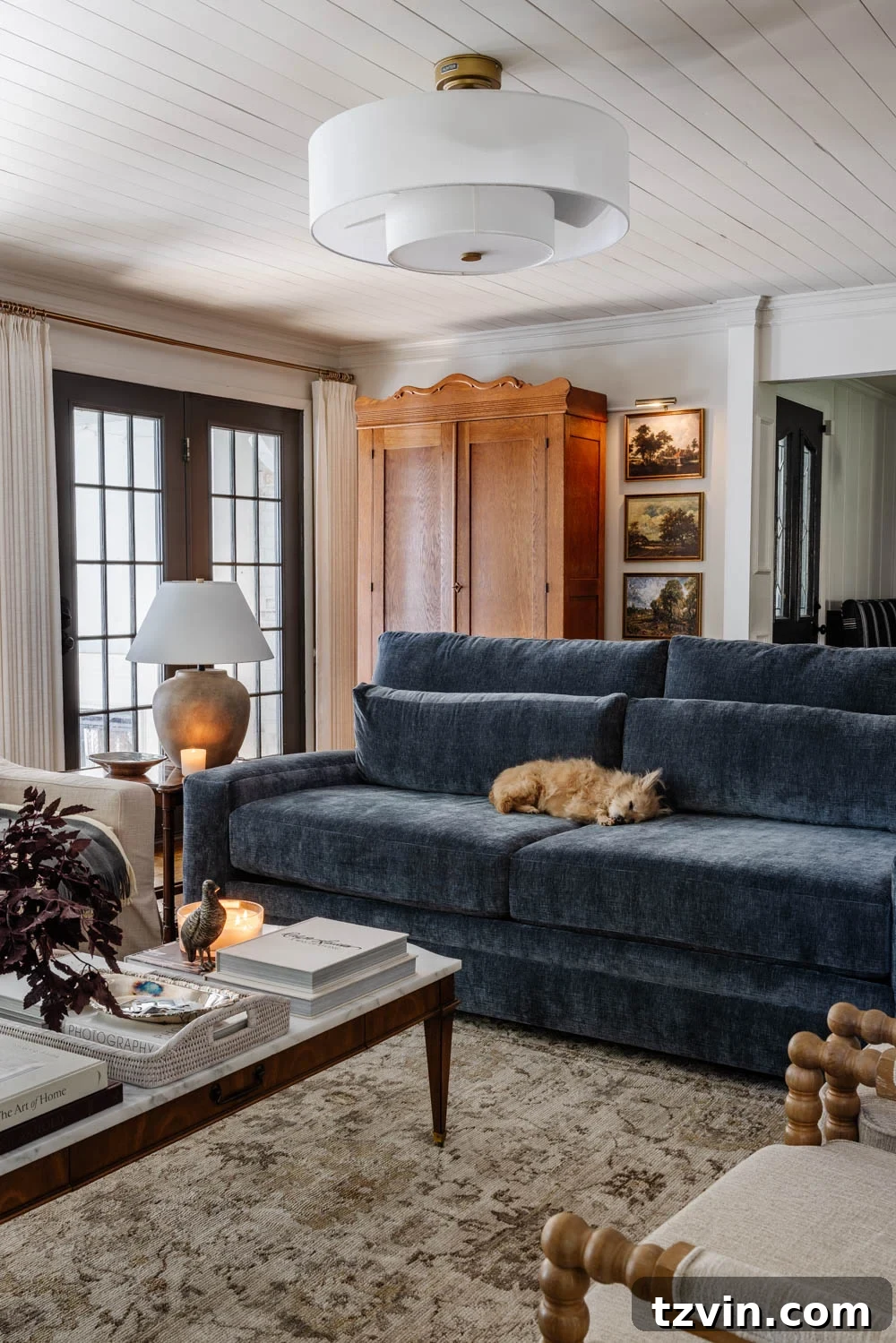 The Living Room Chronicles: An Eight-Year Design Evolution 10 blue sofa in living room with armoire mudroom