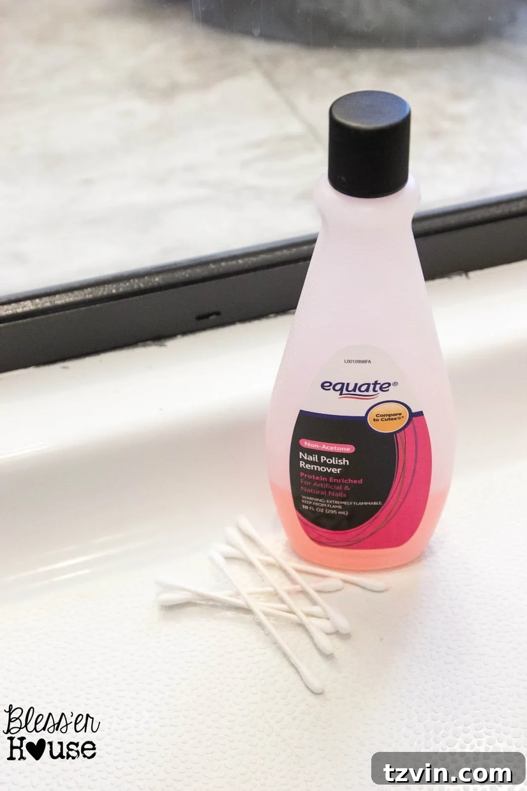 Q-Tip soaked in nail polish remover being used to clean a smudged paint line