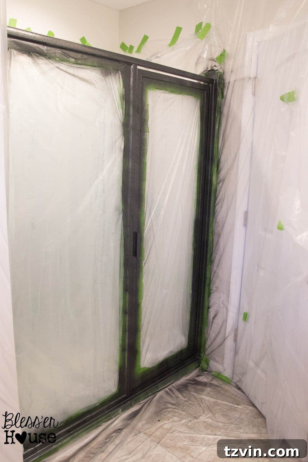 Bathroom covered in plastic drop cloths for spray painting, resembling a quarantine zone