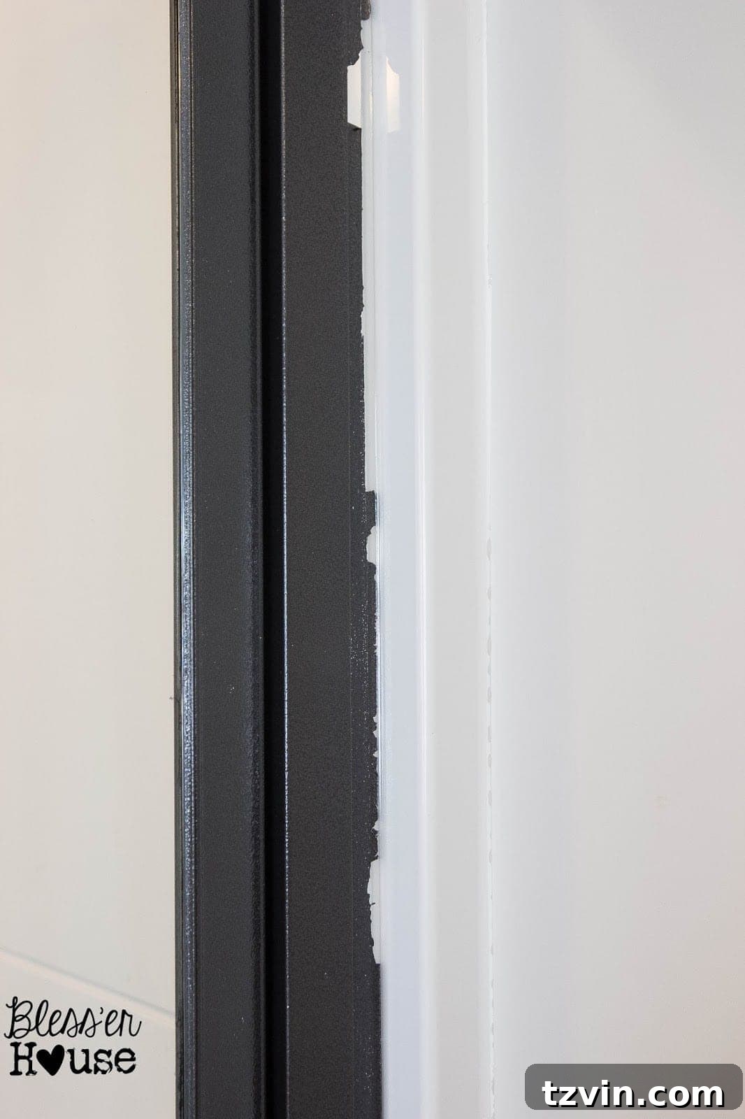 Close-up of spray paint peeling due to improper surface preparation on a shower frame