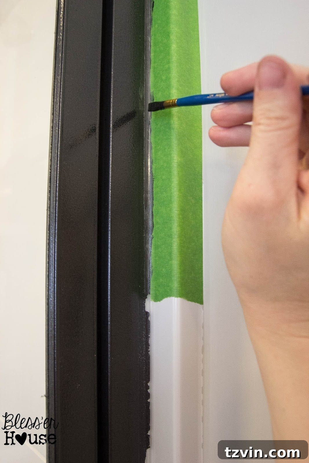 Close-up of a touched-up shower door frame, showing improved paint lines
