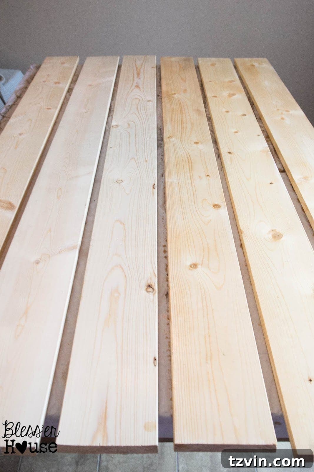A side by side comparison of what regular lumber looks like compared to black tea stained lumber (on the left).