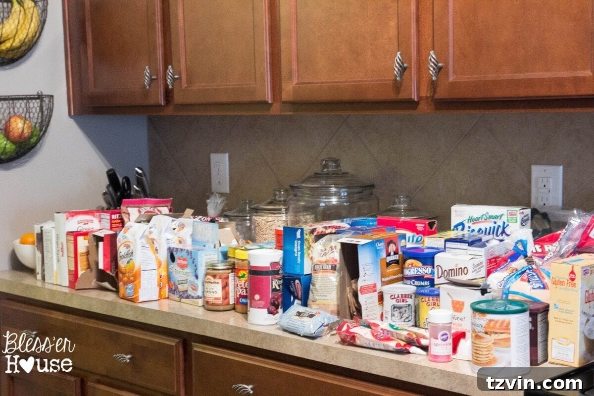 Your Budget-Friendly Guide to a Perfectly Organized Pantry 5 Kitchen countertops covered with pantry items during cleanup