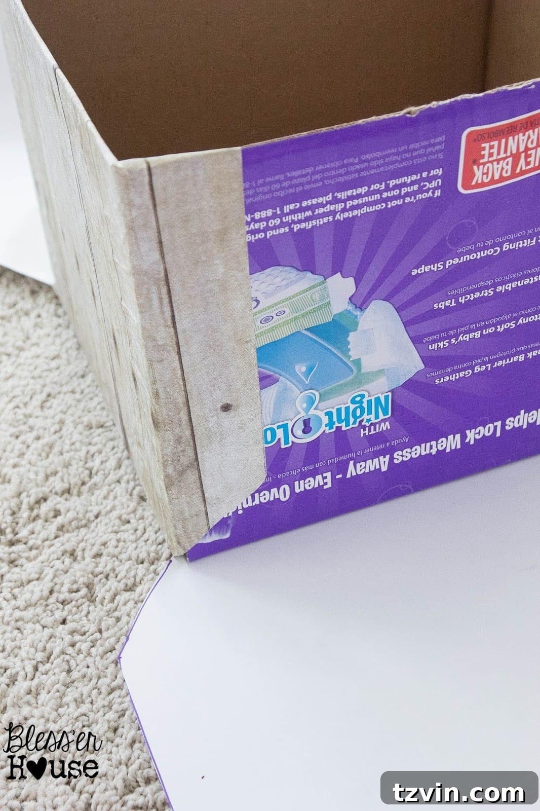 One side of the cardboard box completely wrapped in faux wood paper, showing the neat finished edge.