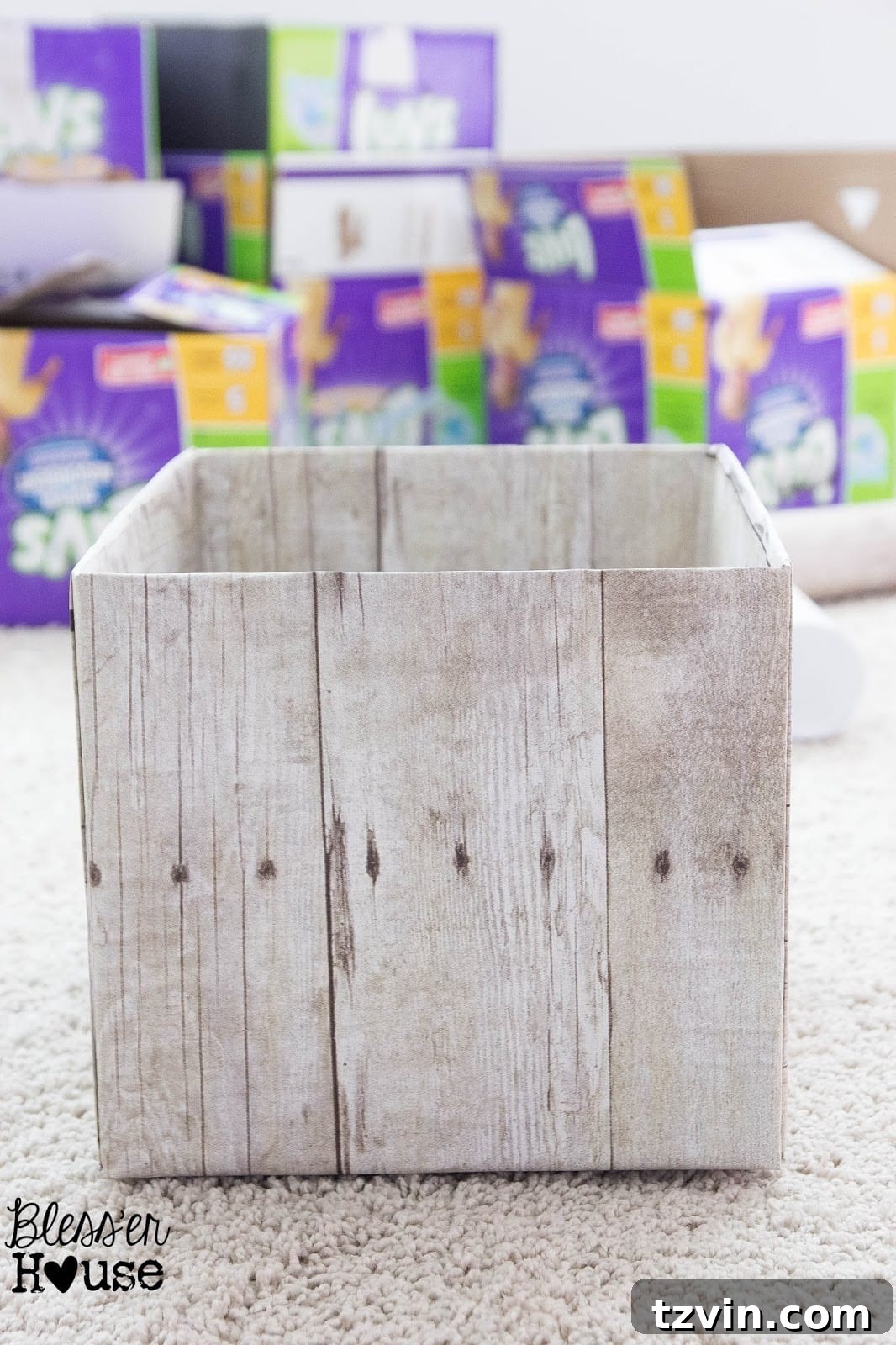 A finished DIY weathered wood pantry crate made from a diaper box, showcasing its realistic wood-like appearance.