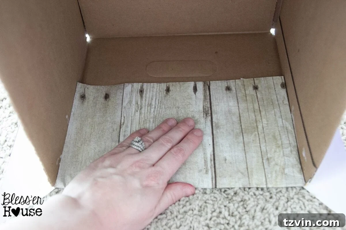 The faux wood paper smoothly applied to the inside top edge of the box, creating a finished look.