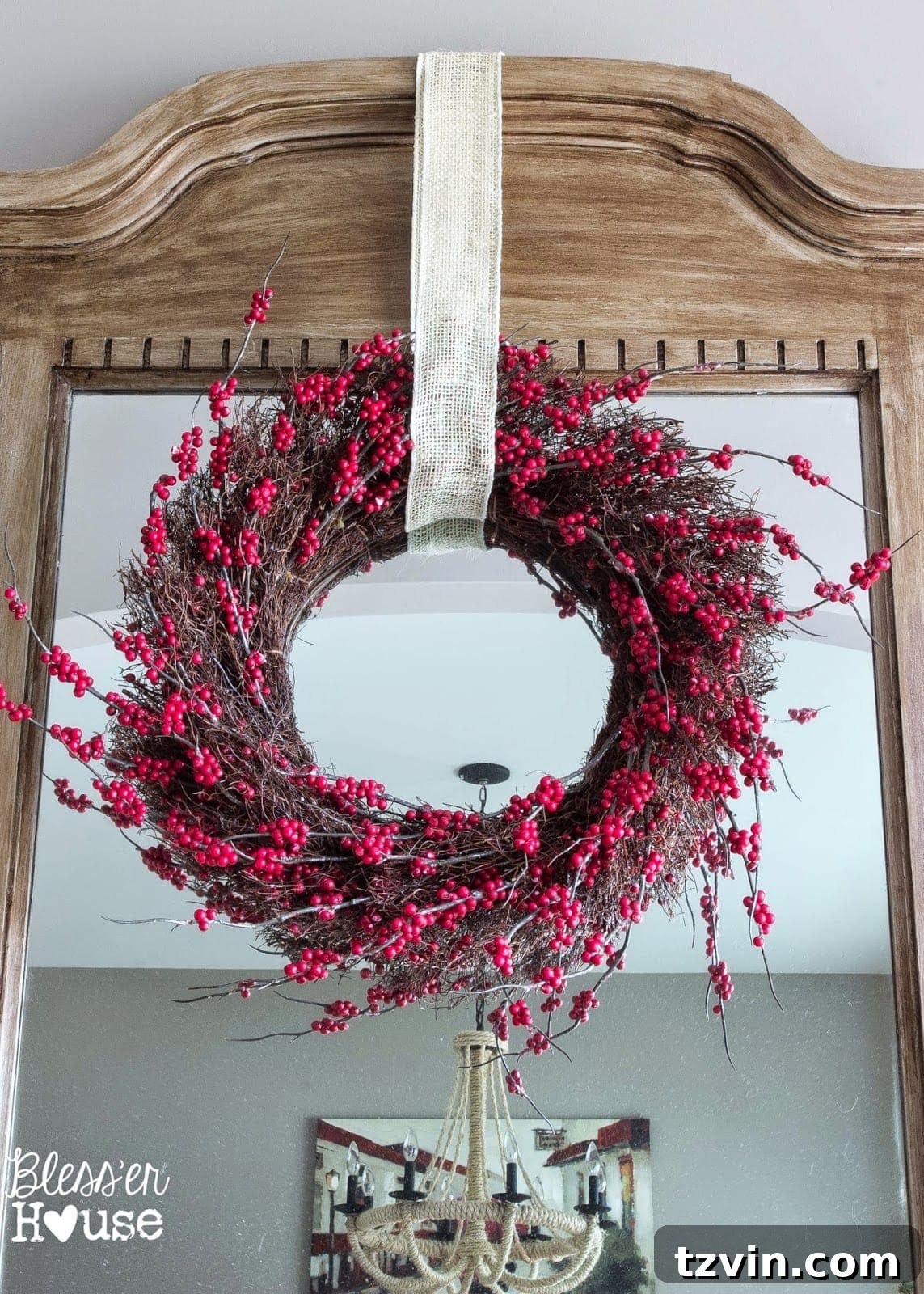 Festive Christmas Decor That Won't Break the Bank 6 An old wreath repurposed on an entry mirror, demonstrating the charm of hand-me-down decorations