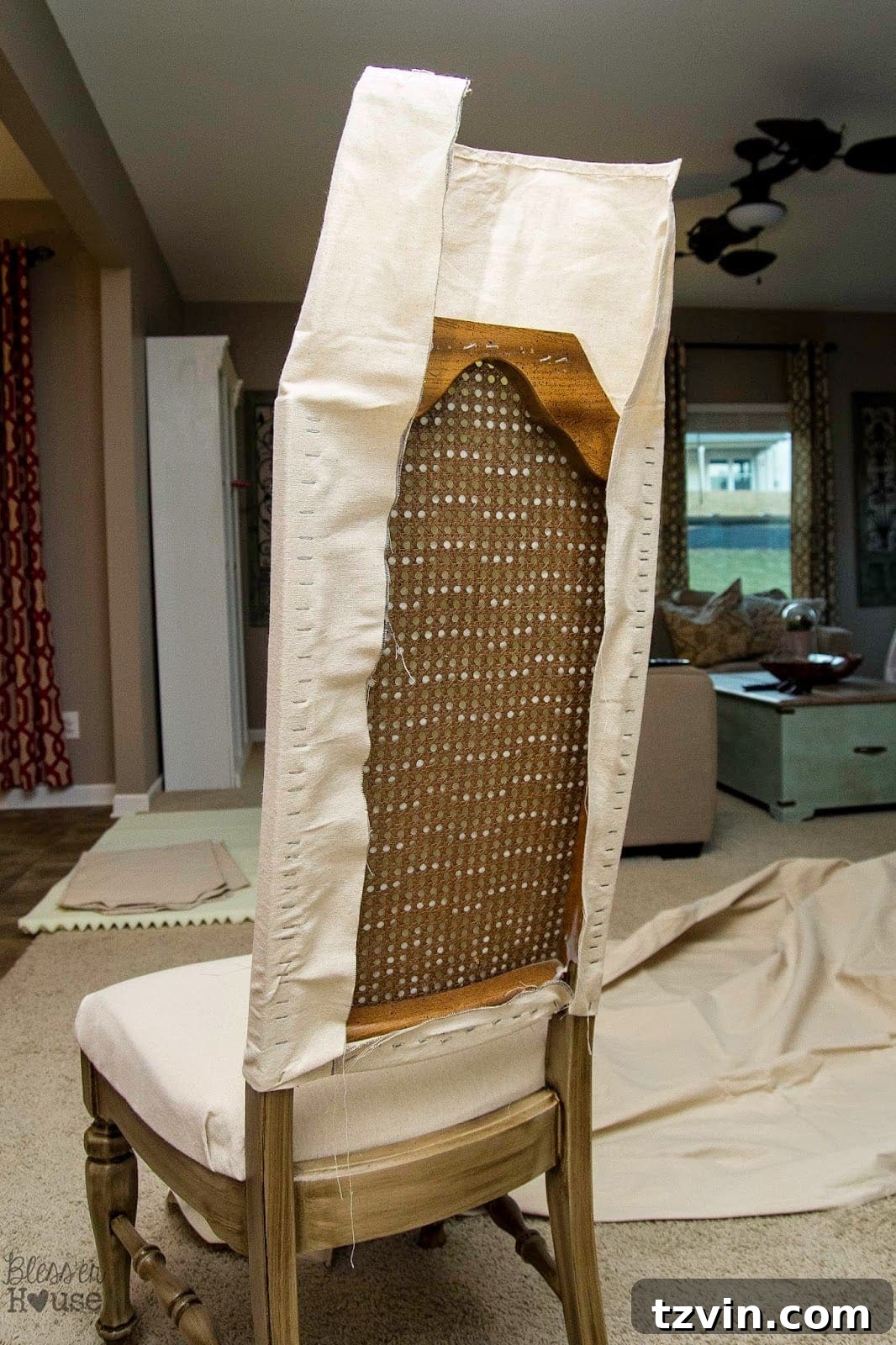 Two people stretching and stapling chair fabric for a smooth finish