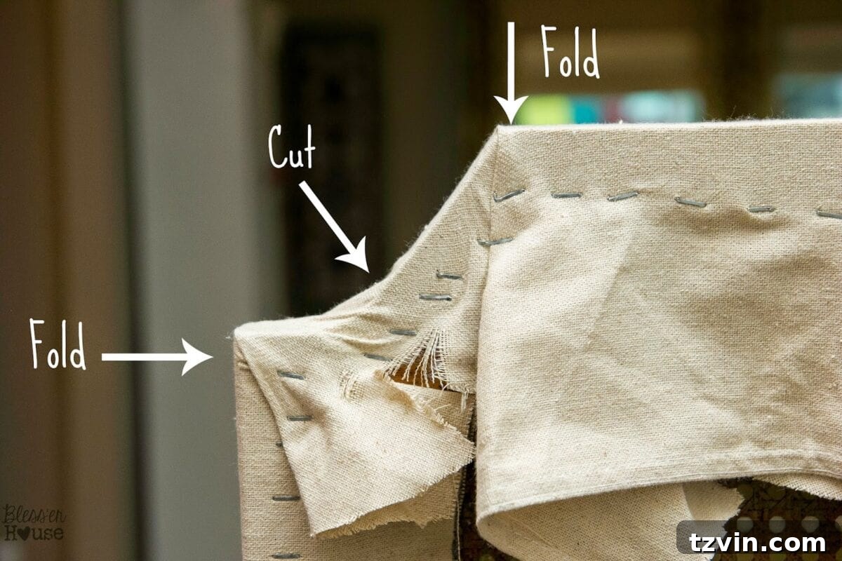 Folding and cutting fabric corners on the top of the chair back