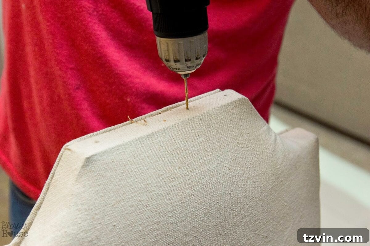 Pre-drilling holes for nailheads on a hard wood chair