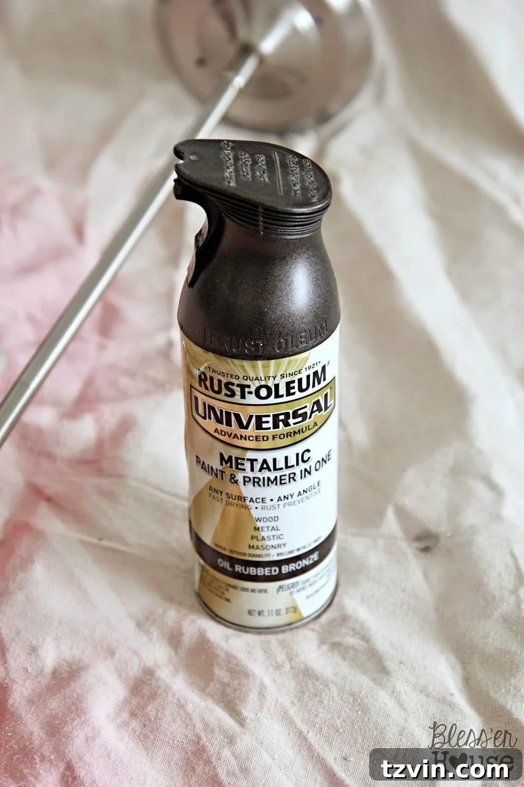 Spray painting the pendant light with oil rubbed bronze