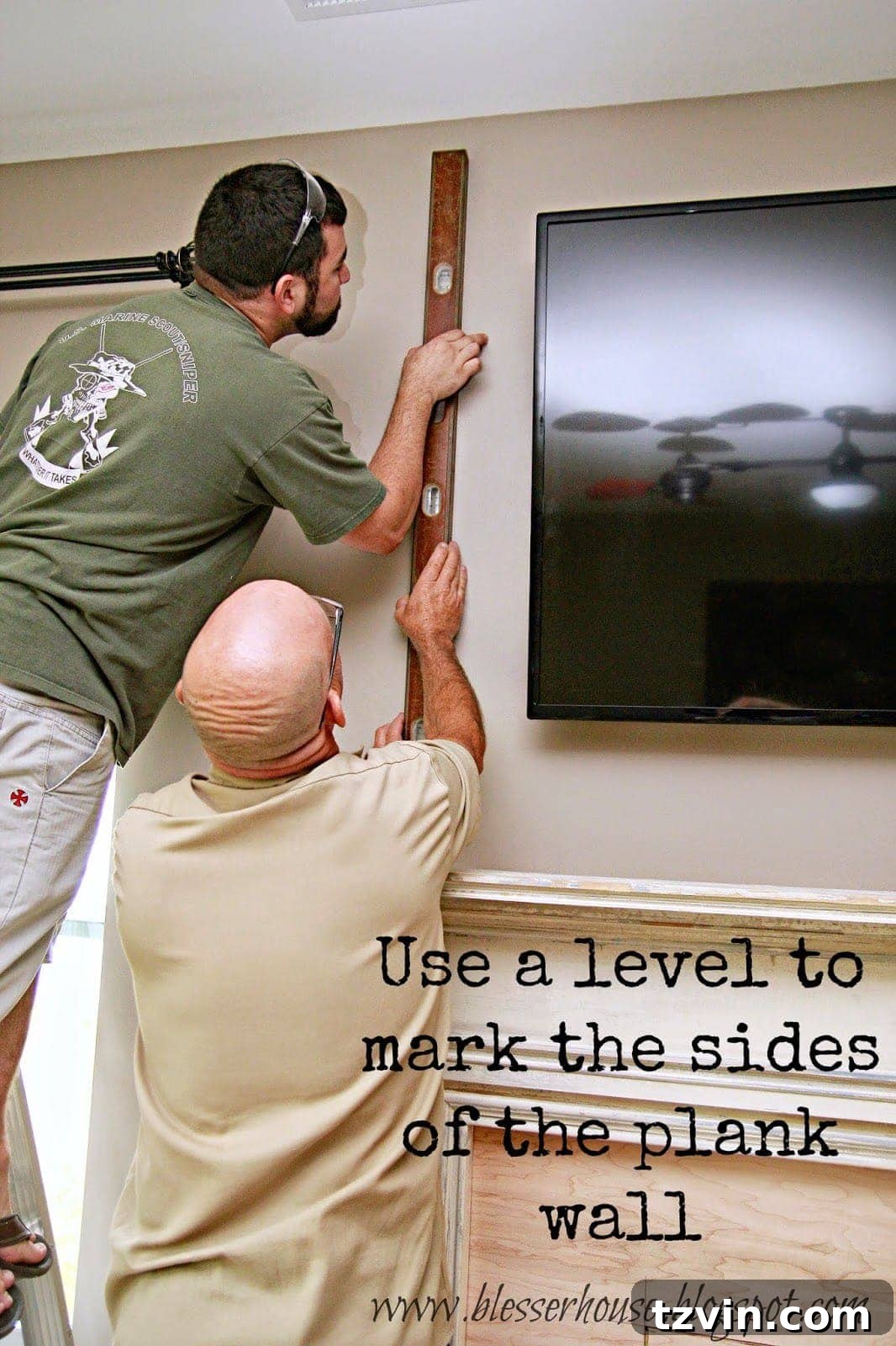 Using a long level to mark the vertical guide lines for a DIY plank wall project, ensuring precise placement and alignment.