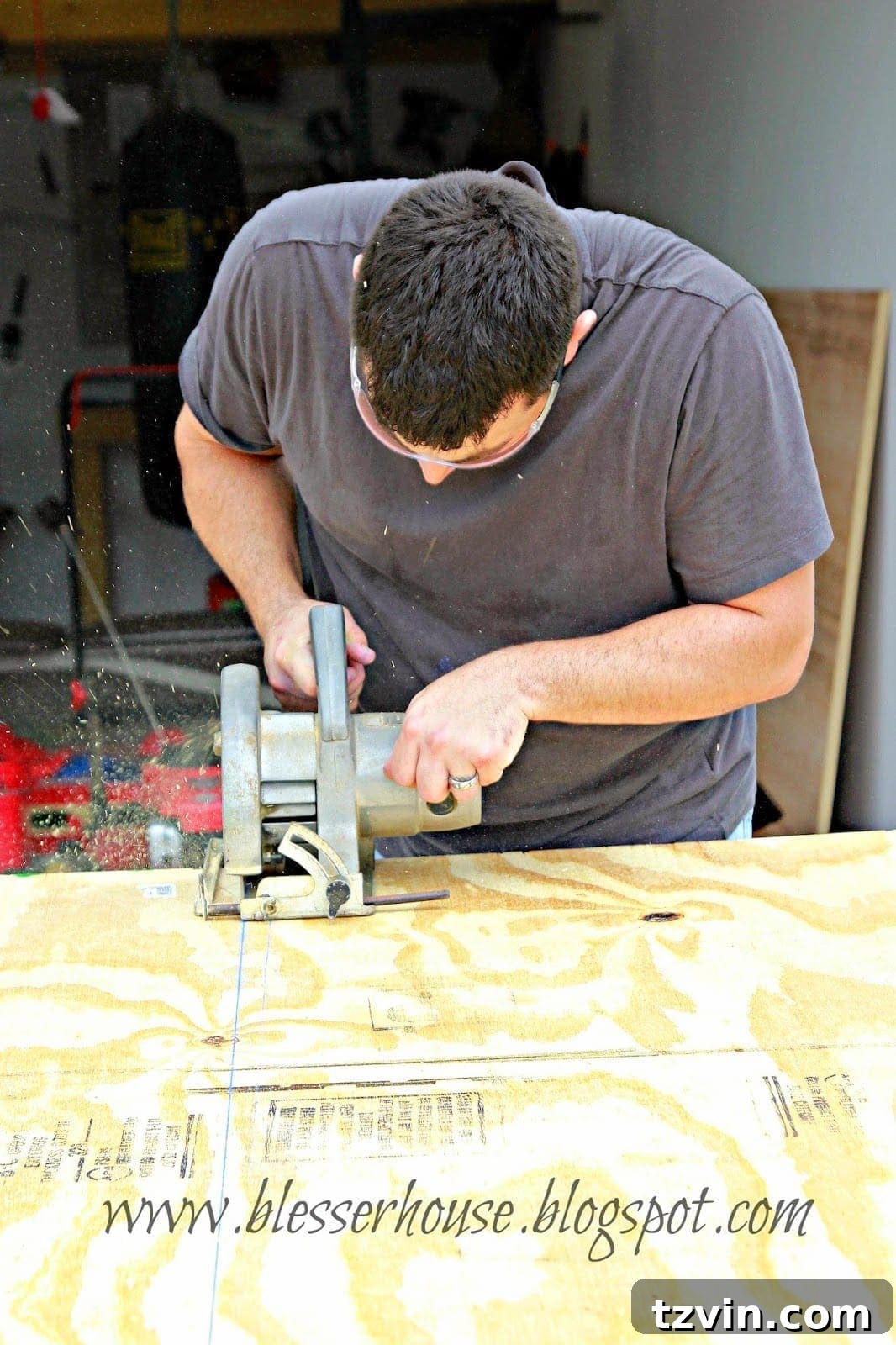 Man cutting a large plywood sheet for the hearth top
