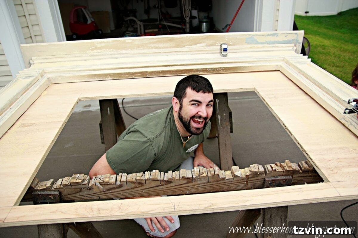 Robert standing proudly next to the faux fireplace structure with the firebox cut out