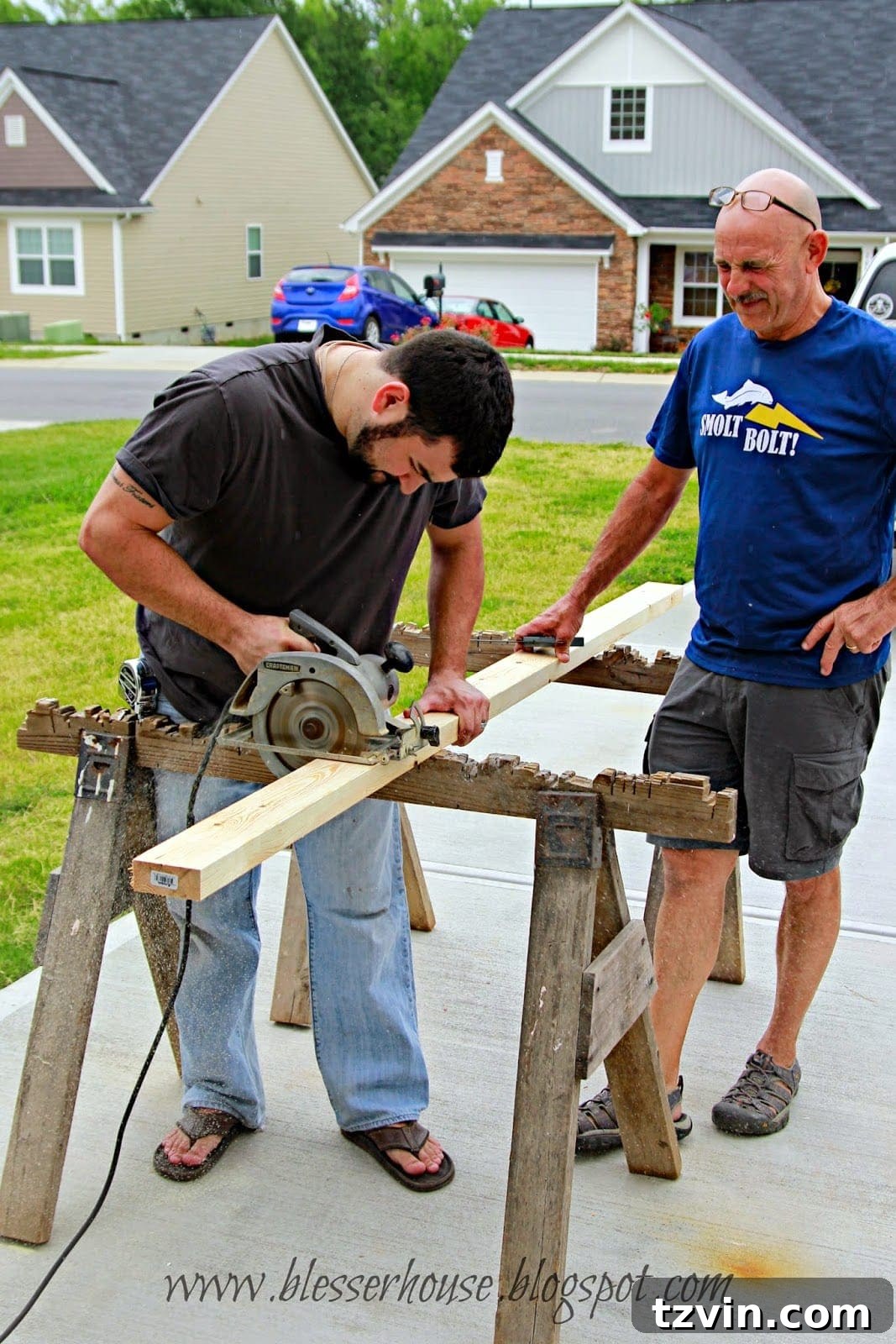 Man using a circular saw to cut wood for the fireplace frame