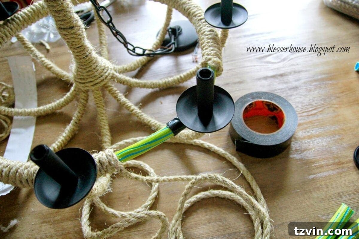 The ends of the rope-wrapped hula hoop being secured with super glue and duct tape