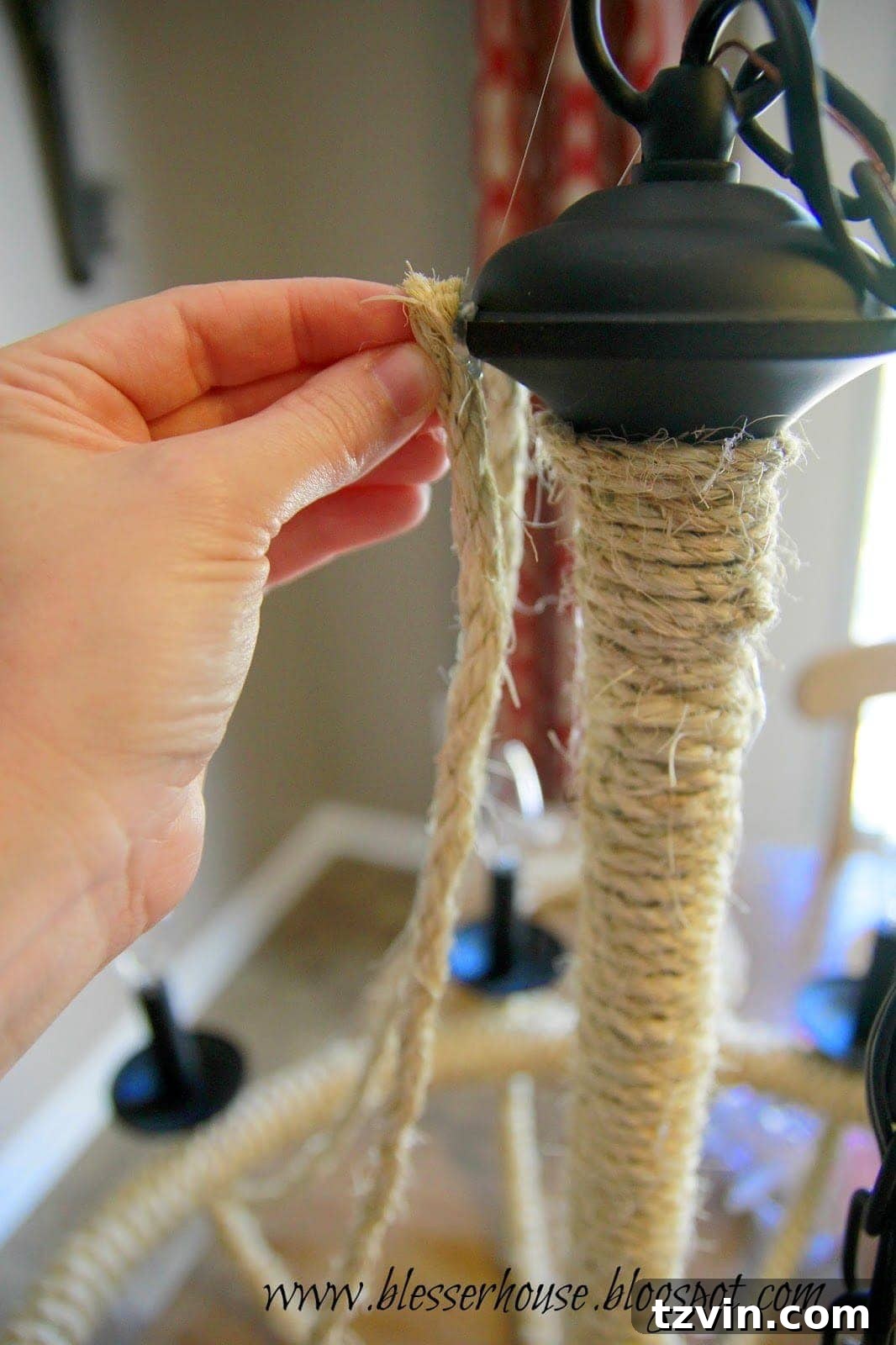 Attaching the first rope swag to the top of the chandelier