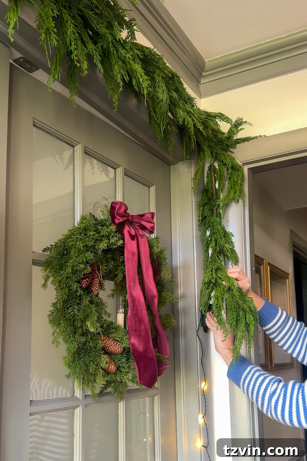 Weaving string lights throughout the garland for a natural glow