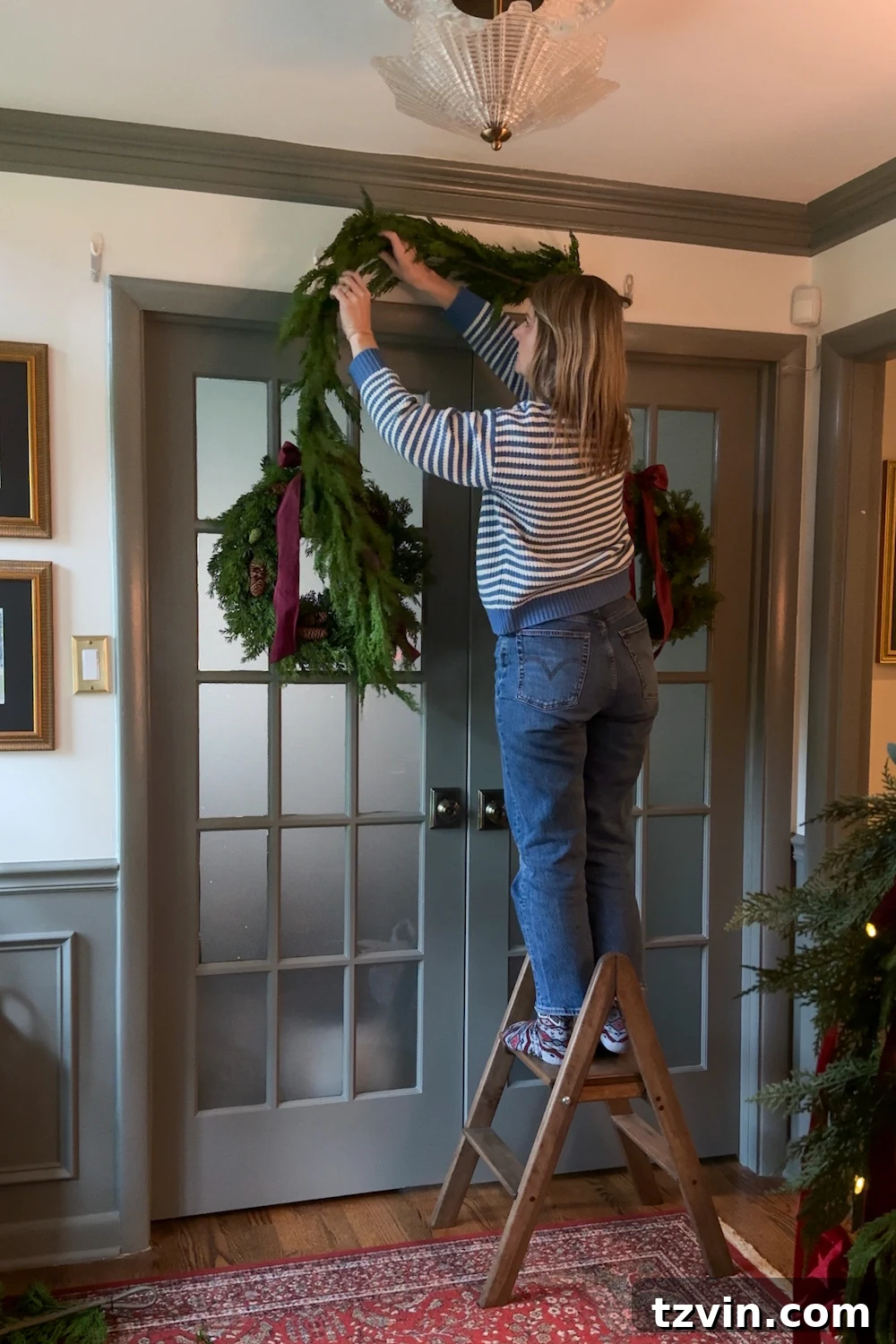 Applying Command Cable Bundlers to a doorway for damage-free garland hanging