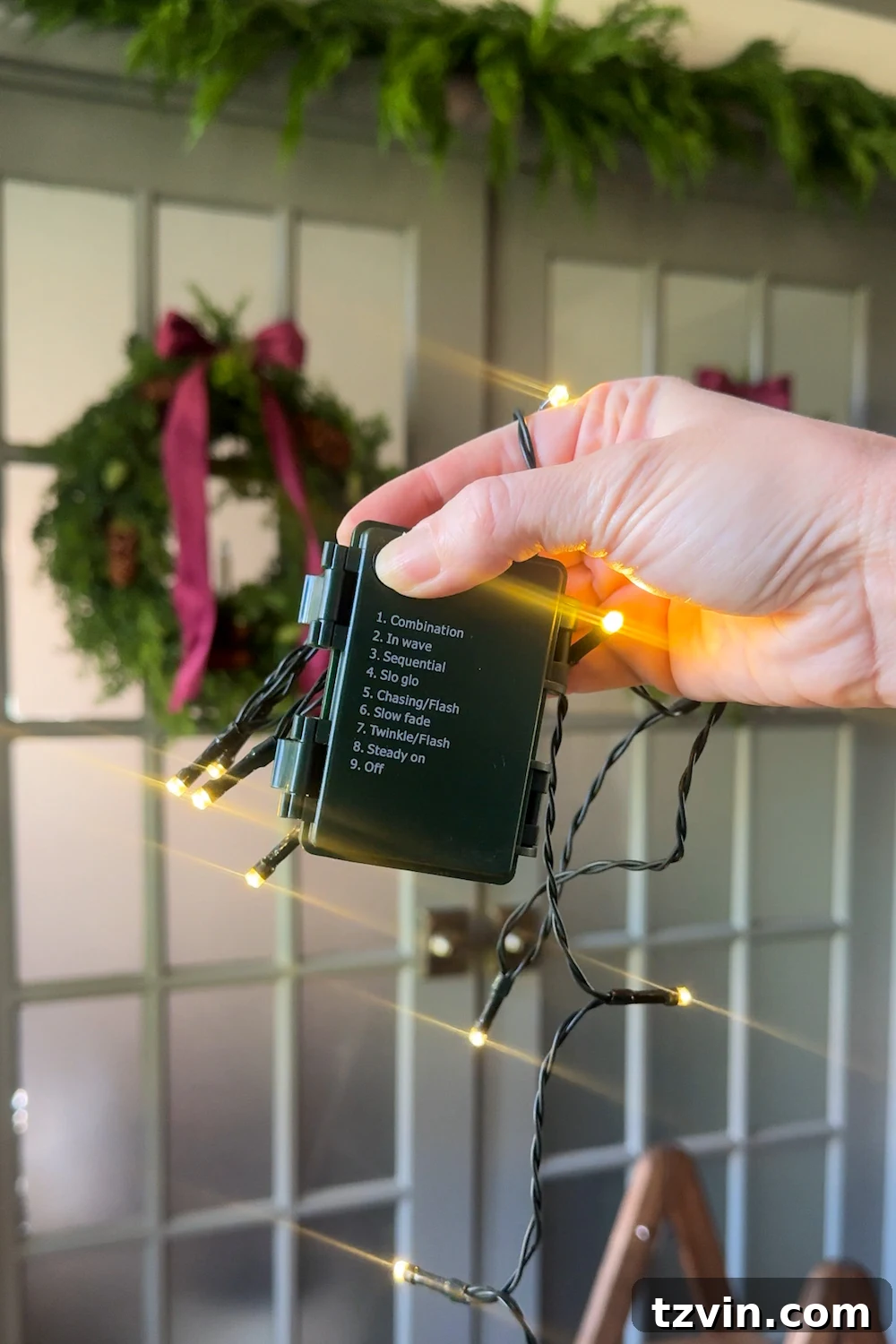 Hanging the base garland around the doorway using Command Cable Bundlers