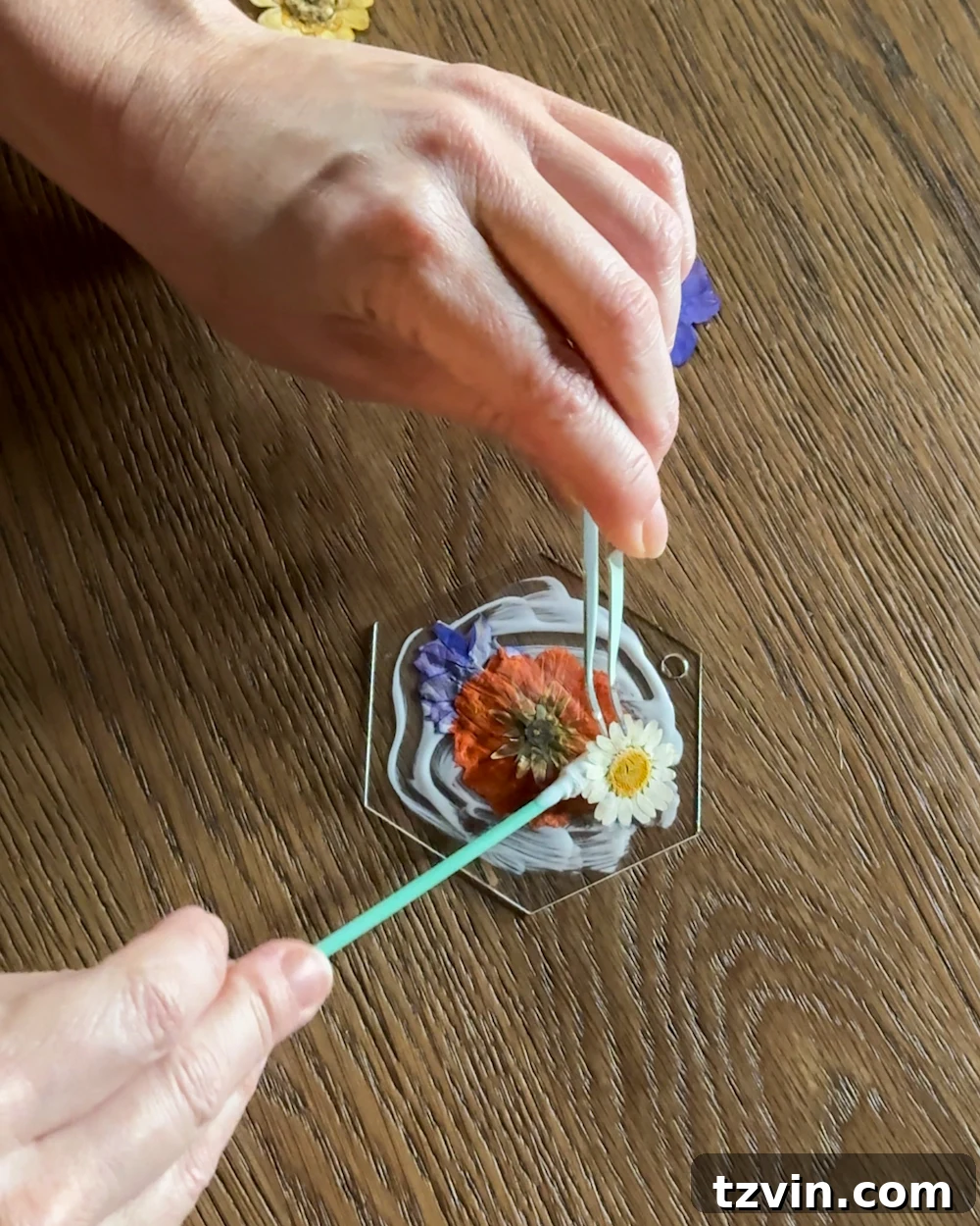 Placing pressed flowers on acrylic tag with Mod Podge