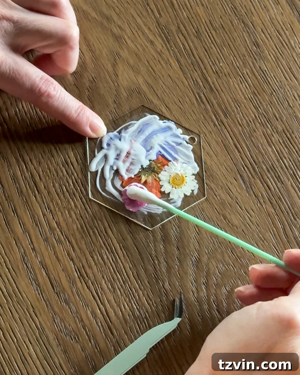 Sealing the pressed flower ornament with Mod Podge