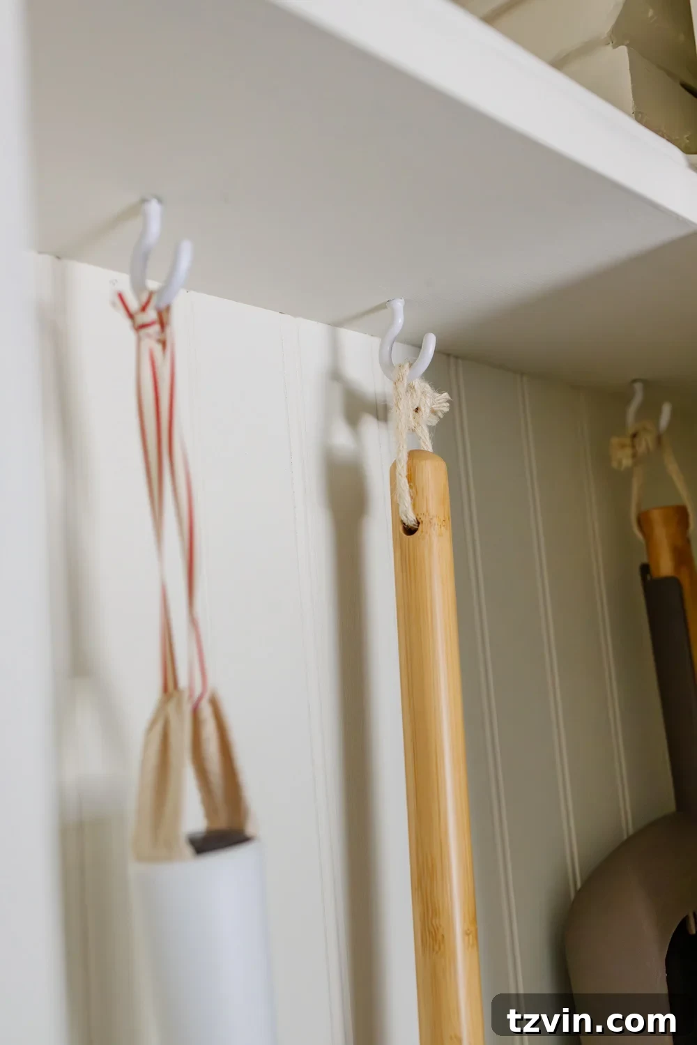Hidden DIY broom cupboard and cleaning supply storage in a laundry room