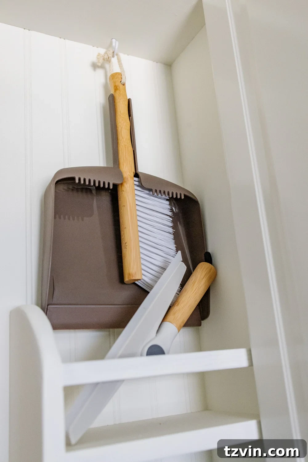 Hidden DIY broom cupboard and cleaning supply storage in a laundry room