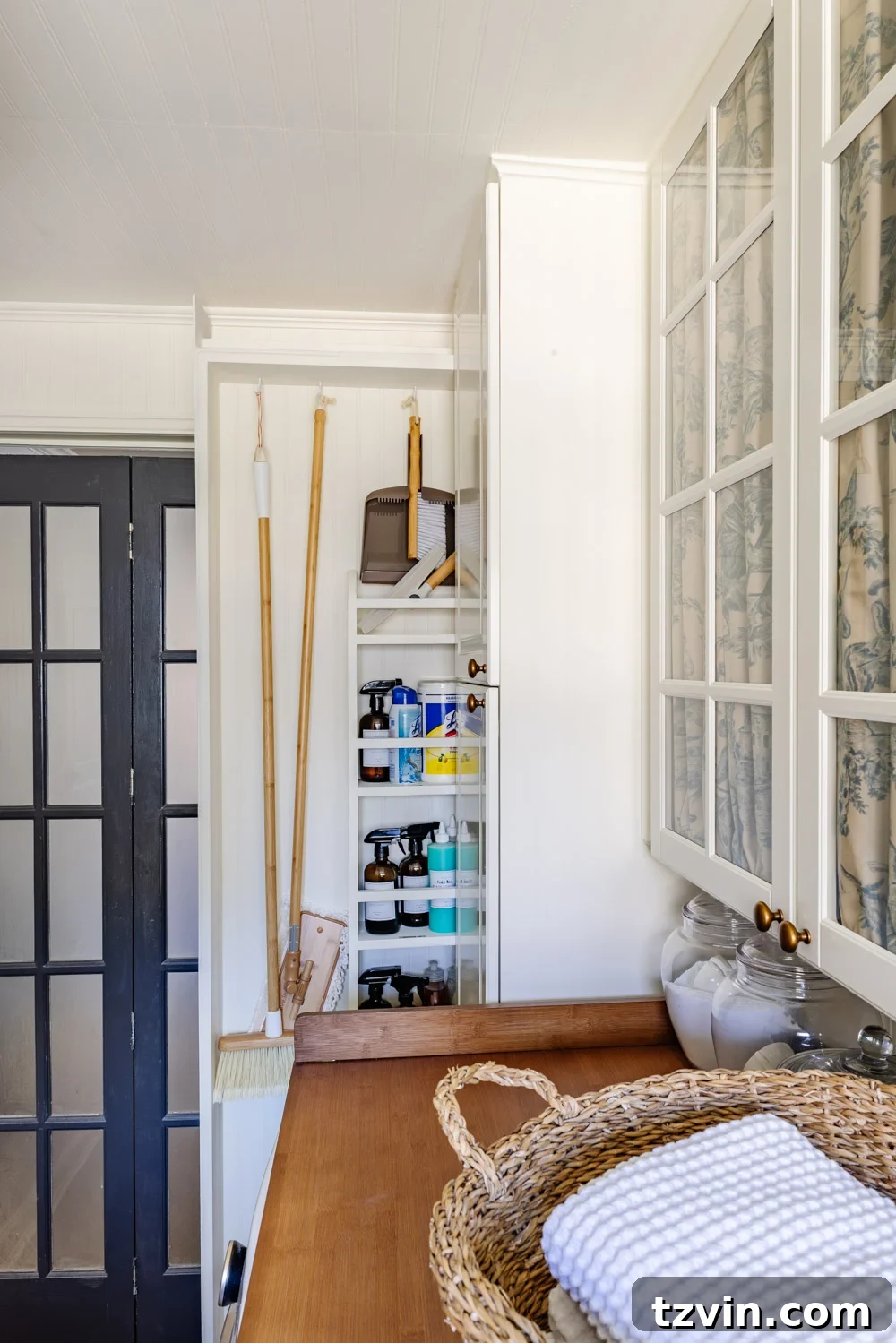 Hidden DIY broom cupboard and cleaning supply storage in a laundry room