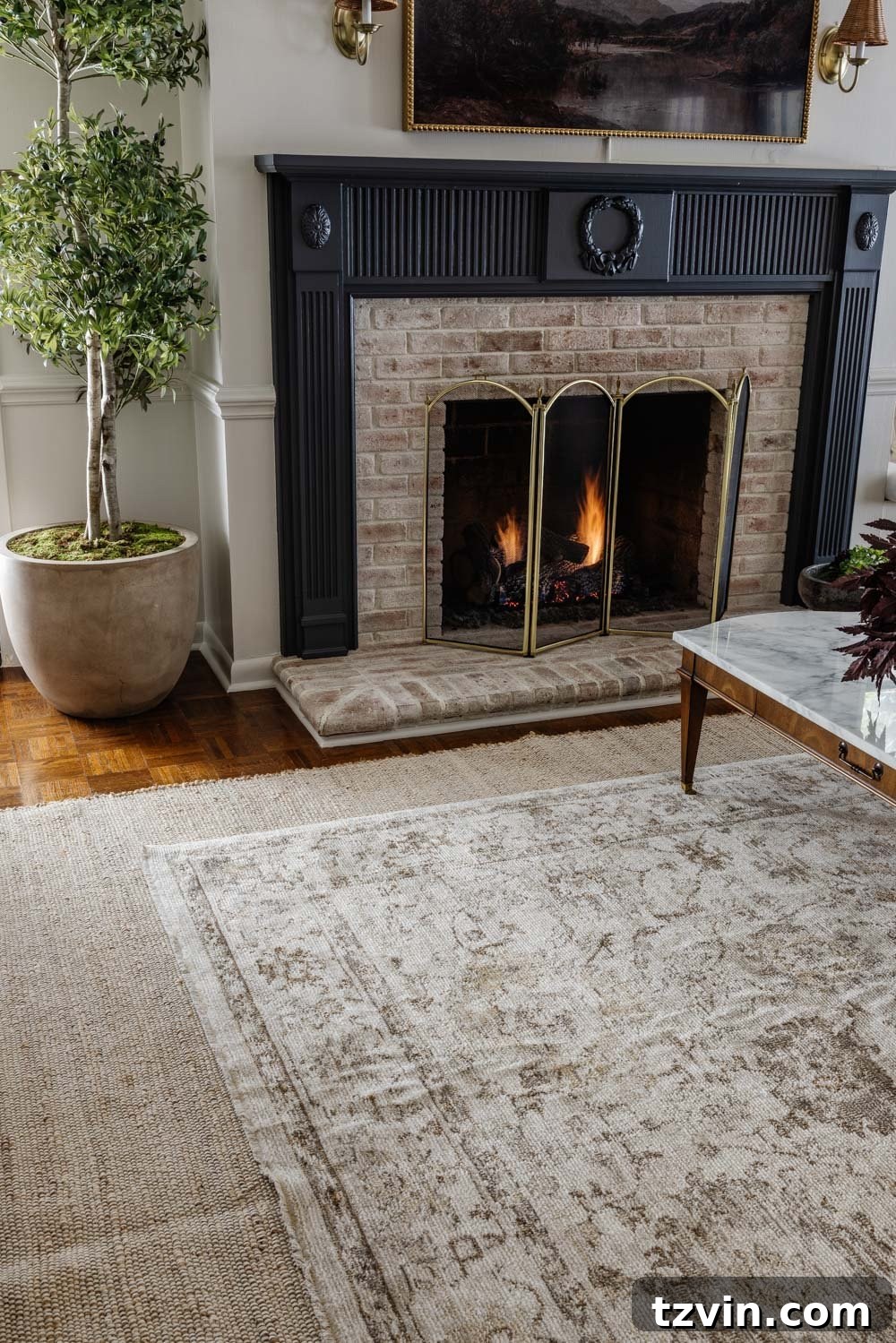 Layering Rugs: Expert Tips and Stylish Combinations 3 A beautifully layered rug arrangement featuring a neutral base rug and a patterned top rug.