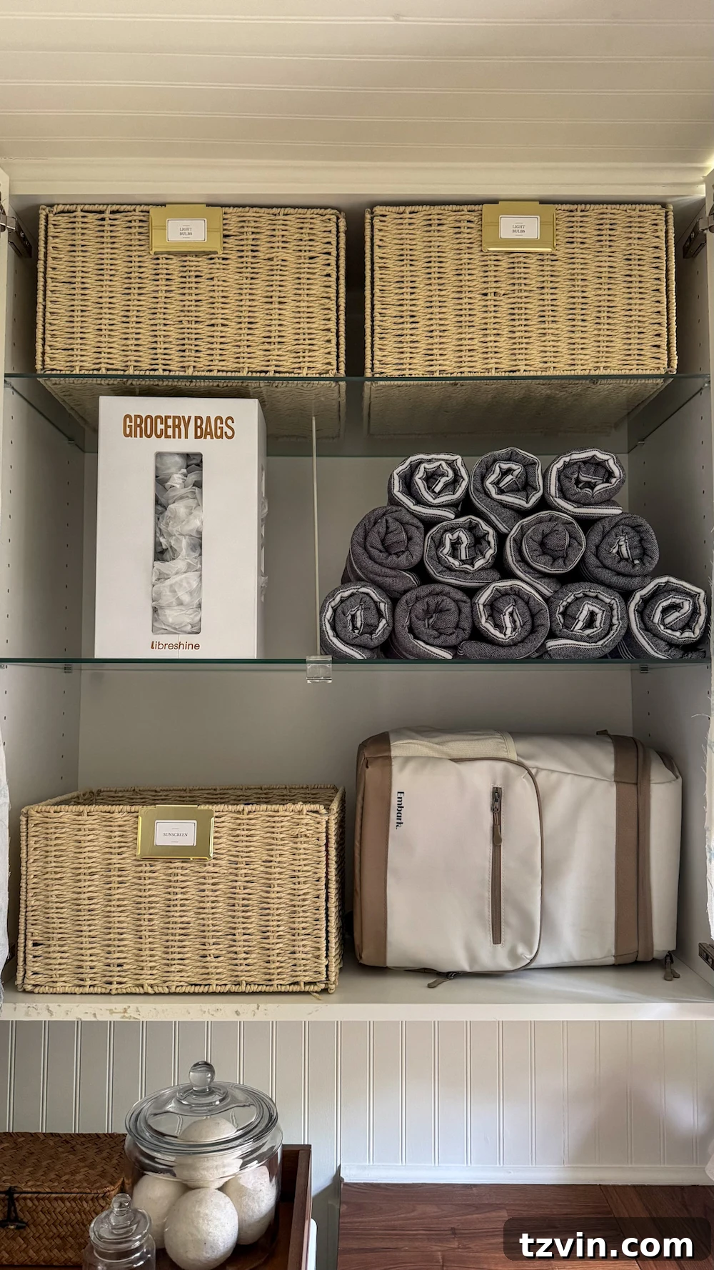 Maximizing Storage in Your Compact Laundry Room: Clever Organization Tips 7 Utility cabinet with pool towels, sunscreen, and grocery bag organizer
