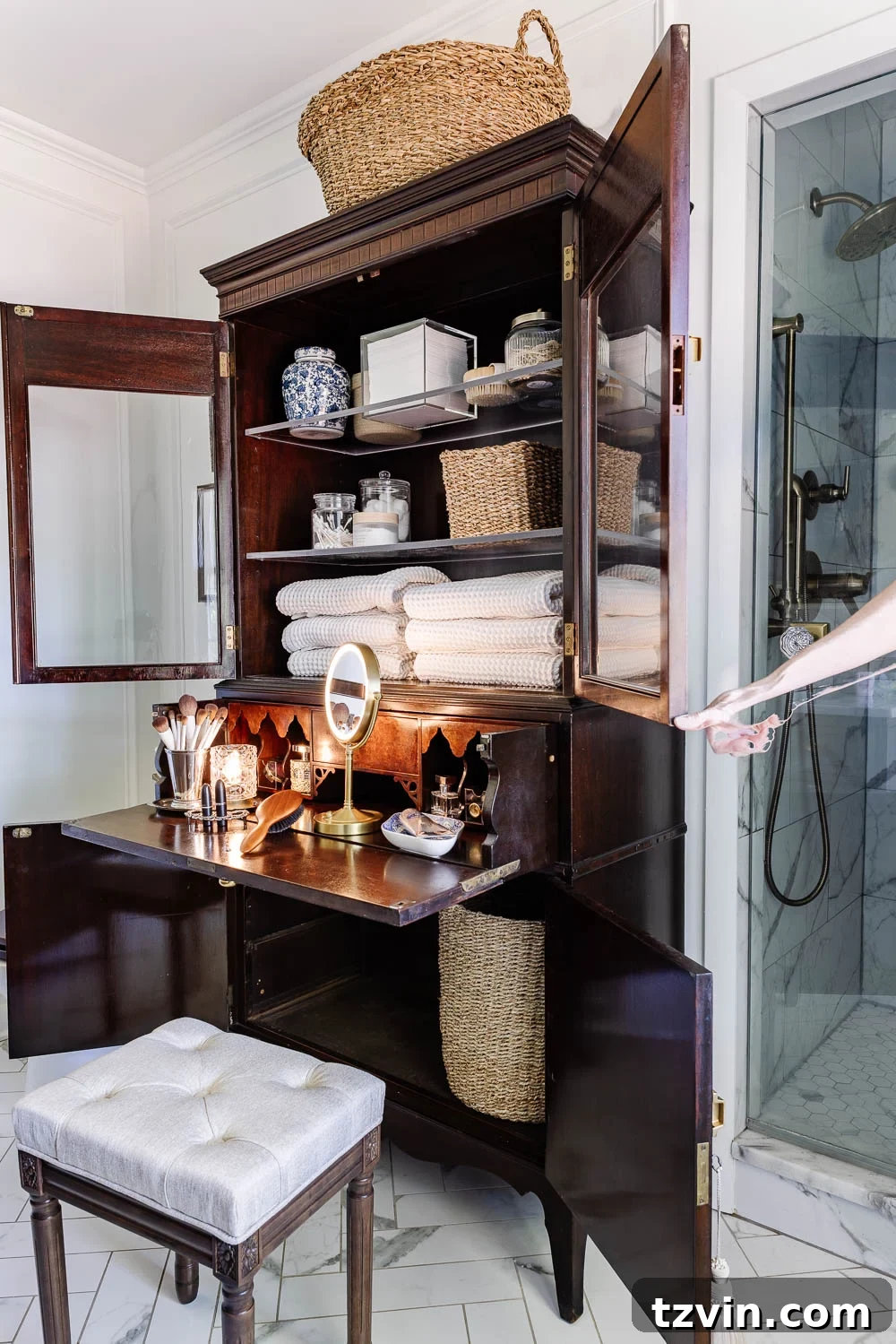 Repurposing a Secretary Desk: A DIY Makeup Vanity for Our Small Bathroom 5 Secretary desk makeup vanity showing its closed form, blending seamlessly into a chic bathroom decor with a small stool and hamper beside it.