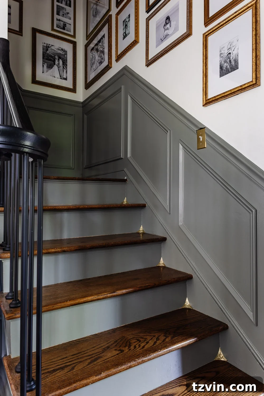 Staircase with gallery wall and brass corners