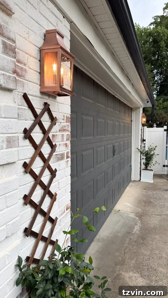 4 Garage Upgrades That Boost Curb Appeal 7 garage curb appeal with copper lanterns, star jasmine, and outdoor trash can hiding panels