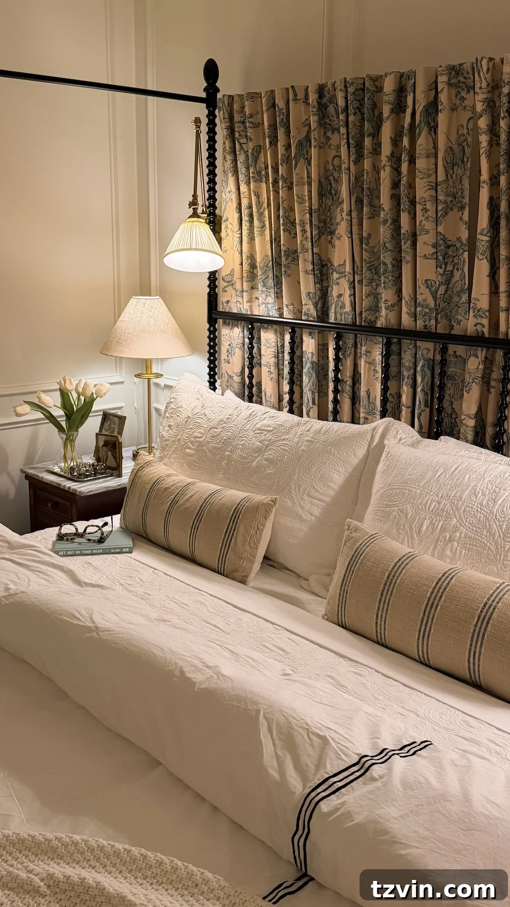 classic modern french country bedroom with layered lighting and canopy bed